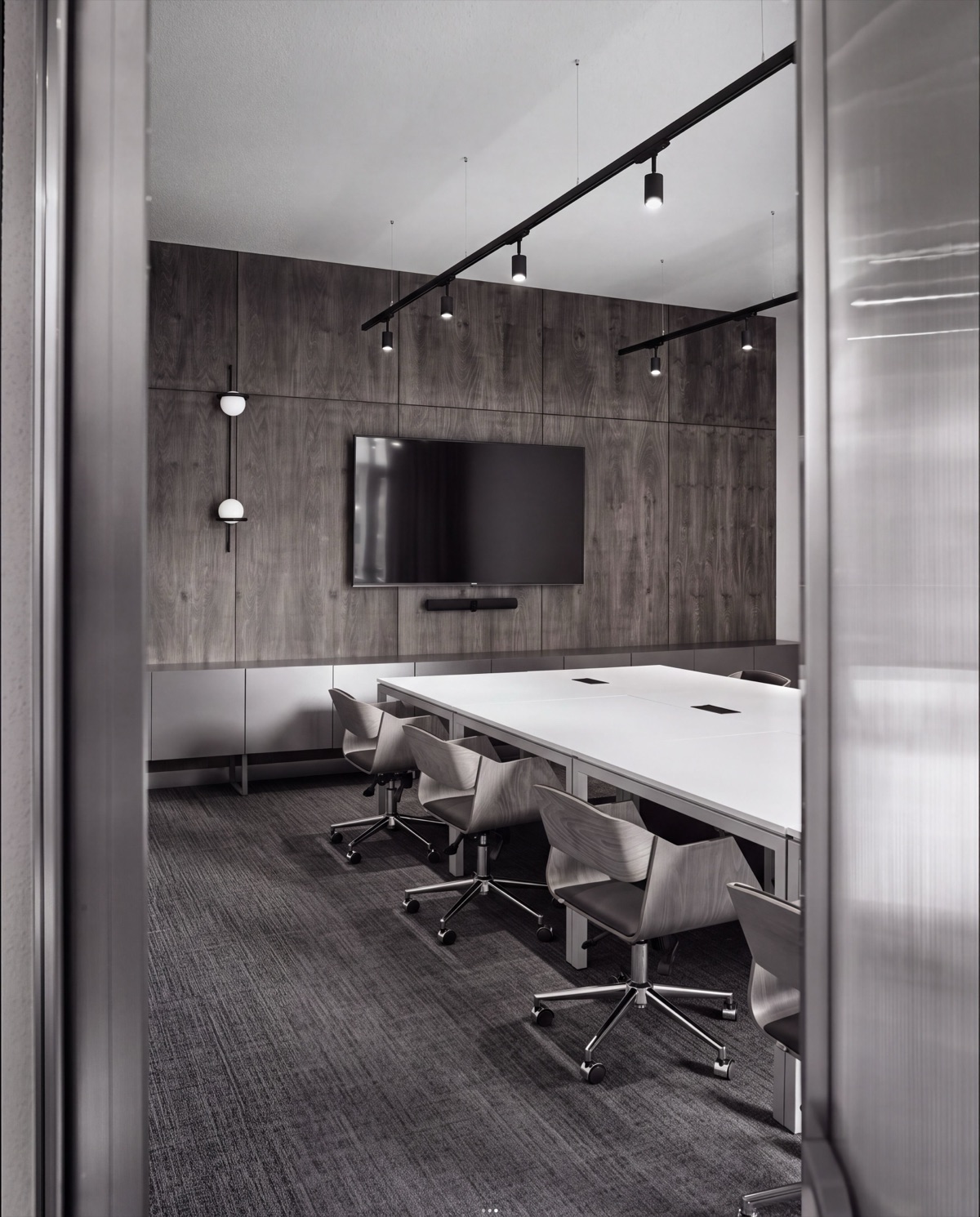 A meeting room set up with a long table and chairs